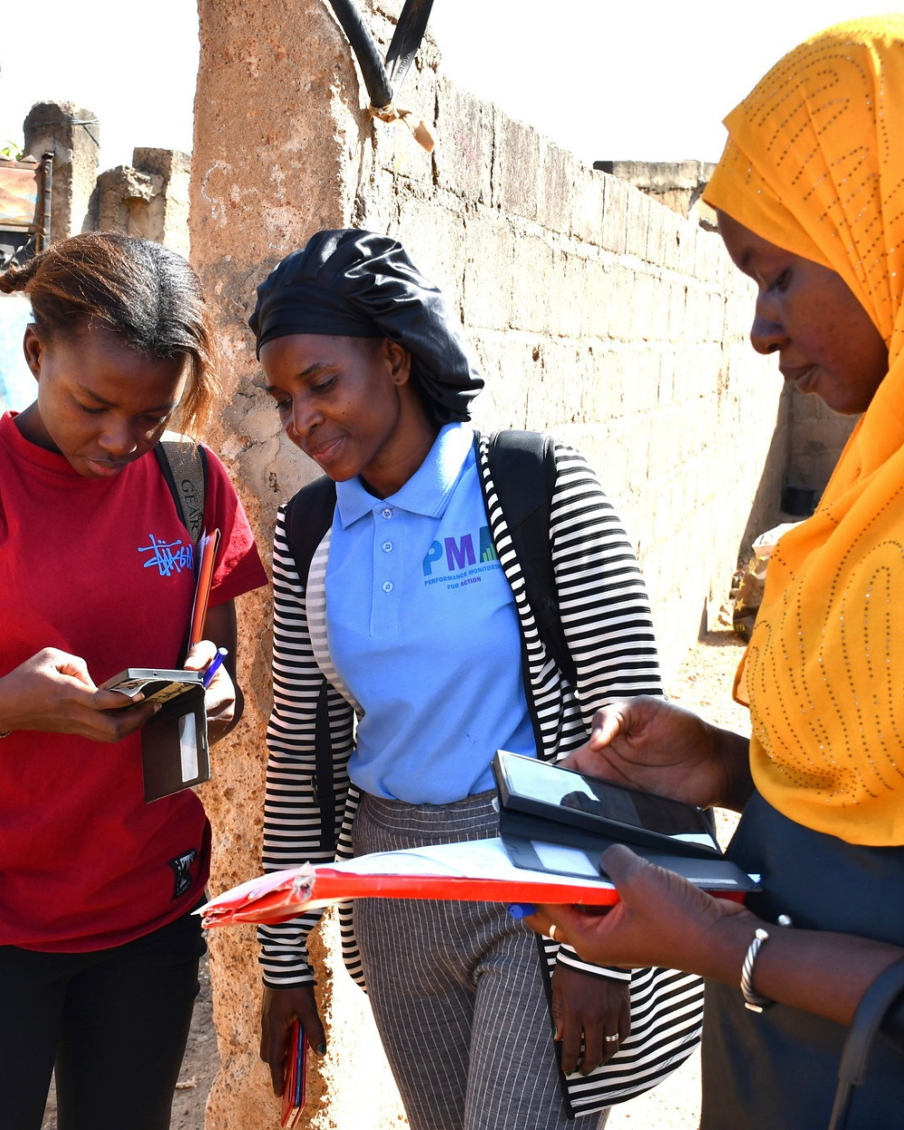 PMA-Female-Data-Collectors-Working-on_Mobile-Phones