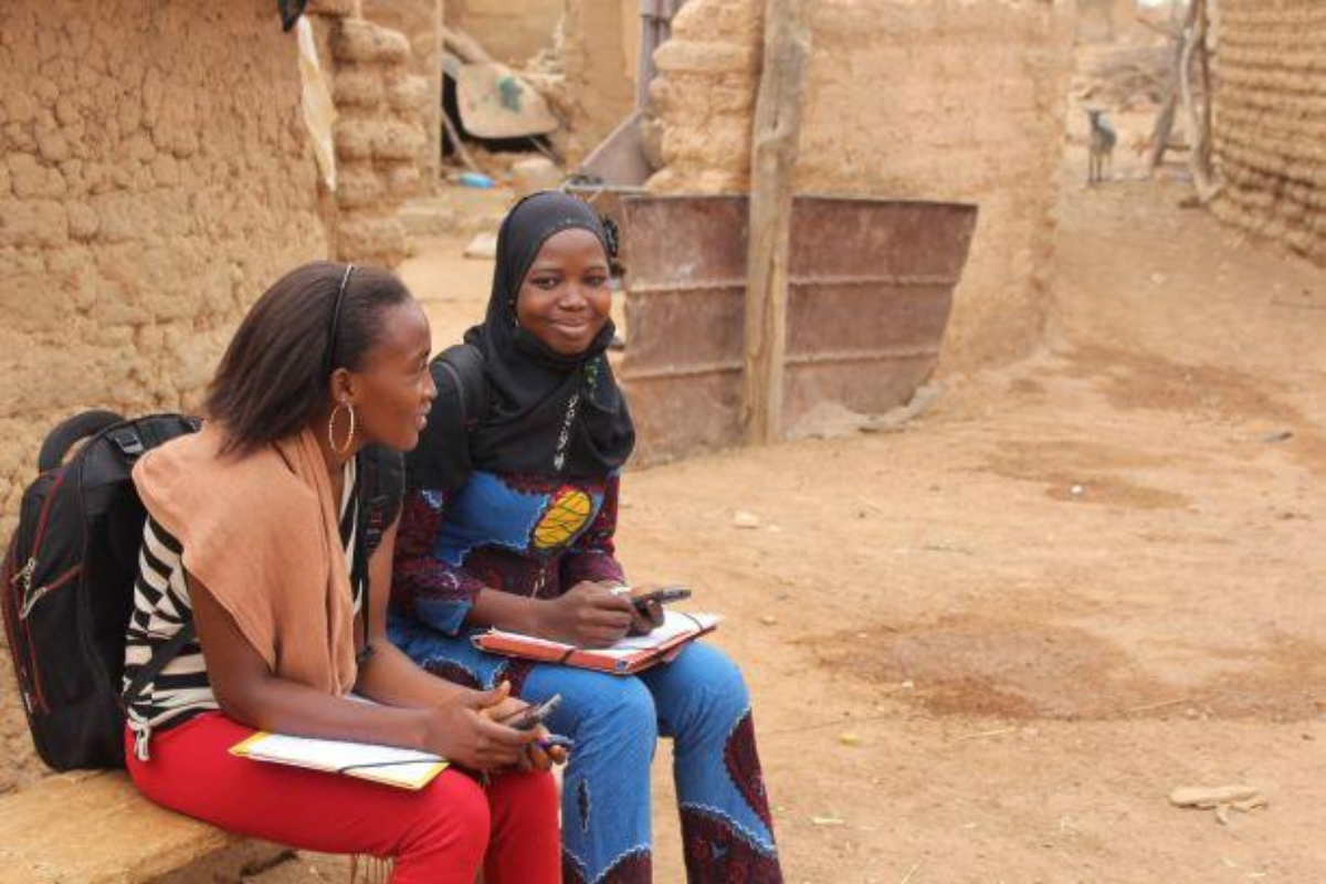 PMA-Two-Female-Data-Collectors-Sitting-Together-with-Mobile-Phones