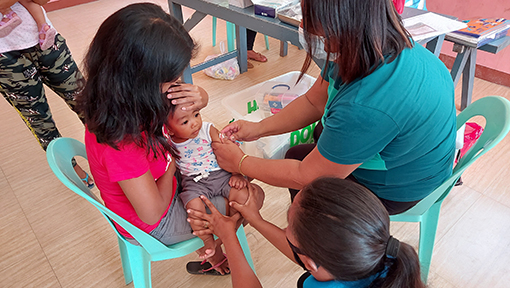 a woman with a baby in a healthcare setting